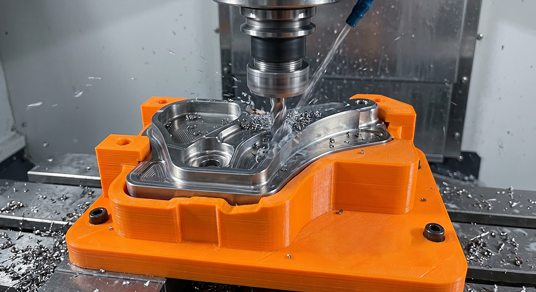 A custom 3D printed fixture securely holding a metal component during high-precision CNC milling.