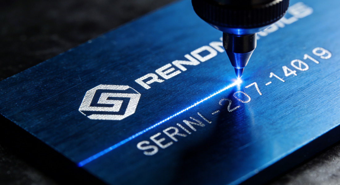 Precision laser engraving process marking a custom corporate logo on an anodized component.
