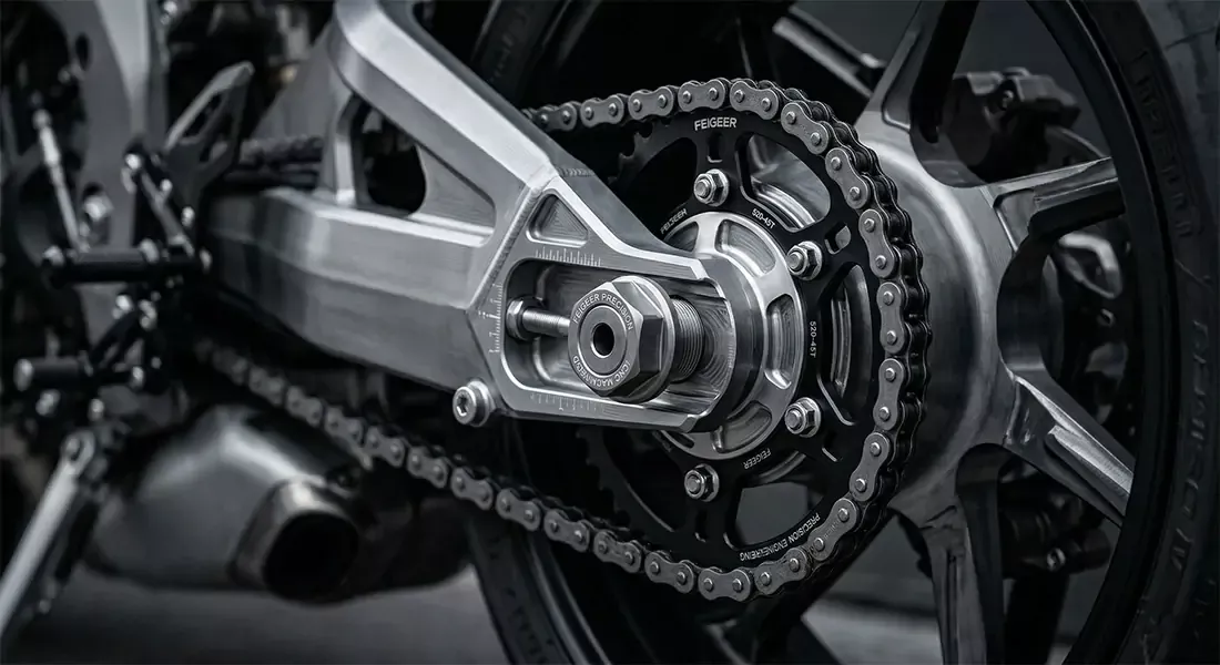 Split view of motorcycle with inverted gold forks, radial brakes, and aluminum swingarm.